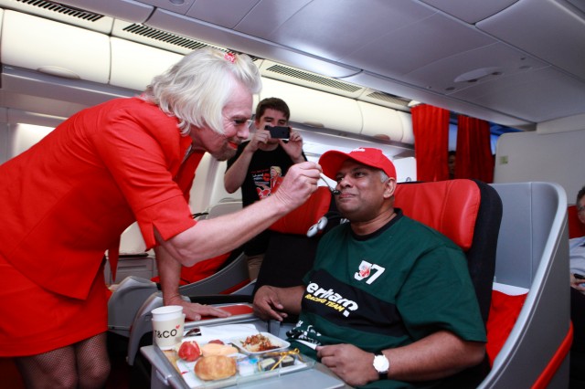 Sir Richard Branson gives that little personal touch to Tony Fernandes from Air Asia - Photo: Adam Lee, Air Asia