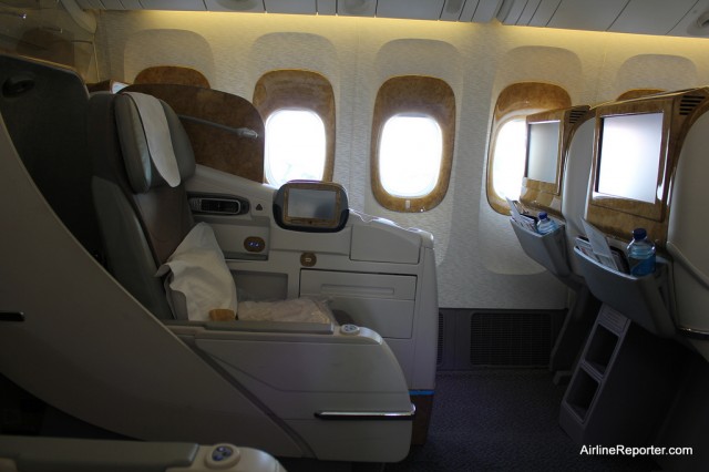 Emirates configures their Boeing 777s with a 2-3-2 layout in Business Class. Notice how the windows have buttons to move the shades.