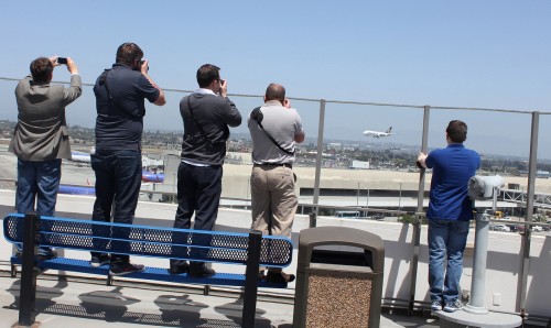 AvGeeks on top of the Theme Building at LAX taking photos of a Singapore Airlines Airbus A380.