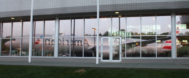 American's sixth Boeing 777-300ER reflects off the Museum of Flight. Photo by Brandon Farris. 