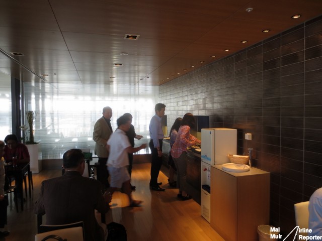 Lining up to a whole in the wall? They are not crazy, they are just getting their meal from the Cooked to Order Noodle Bar in the ANA Lounge - Photo: Mal Muir | AirlineReporter.com