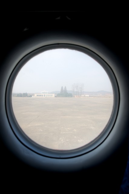 Looking out of the window at the Sondok terminal from seat 9A. 