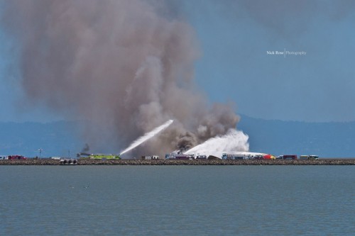 Fire trucks tend to Asiana Airlines Flight 214 at SFO. Photo by Nick Rose.