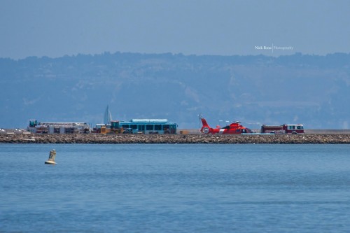 A Coast Guard helicopter lands next to the wrecked airliner. Photo by Nick Rose.