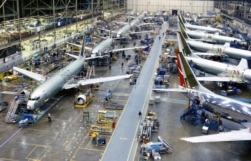 The moving assembly line at Renton at the time of its opening in 2002 appears left-of-frame. The original static assembly line on the right side of the frame provides a fascinating contrast. Image Courtesy: Boeing