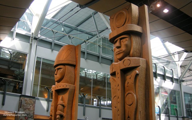 "Female & Male Welcome Figures" by Susan A. Point In the Customs Hall - YVR