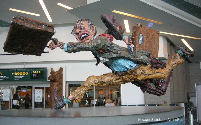 Ever feel like this? "The Flying Traveller" by Patrick Amiot & Brigitte Laurent Just past Domestic Security - "C" Pier - YVR