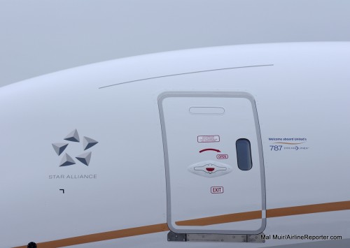 A sign on the left side of the plane lets you know you are boarding a 787.
