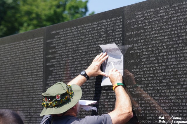 A Veteran takes a tracing of the names on the Vietnam Veterans Memorial - Photo: Mal Muir | AirlineReporter.com