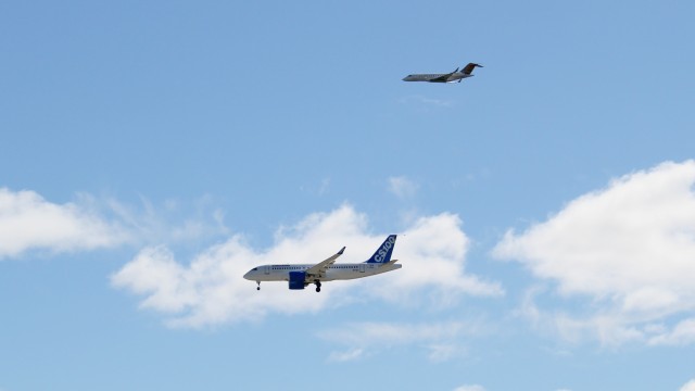 Bombardier CSeries FTV1   does a flyby of YMX, with the Global 5000 chase plane. Photo: Howard Slutsken