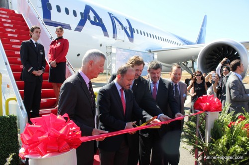 A delivery ceremony wouldn't be complete without the classic ribbon cutting of executives.