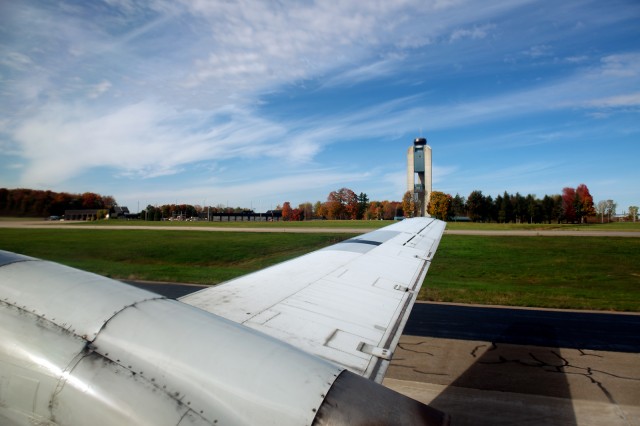 The right wing of C-FTAP and Mirabel's control tower through 57 year old glass. Photo by Bernie Leighton | AirlineReporter