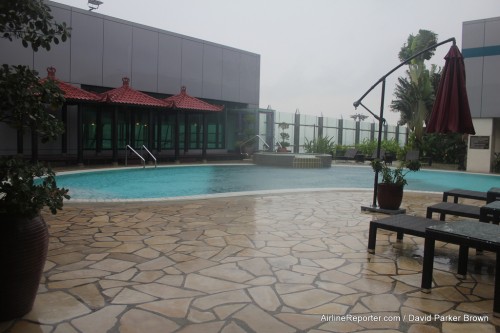 Oddly there were no passengers making use of the over-flowing pool during a heavy down-pour.