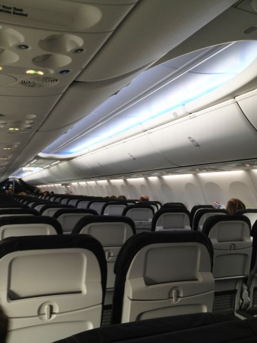 The Boeing Sky Interior provides updated and larger overhead bins, as well as LED lighting. Image from Alaska Airlines.