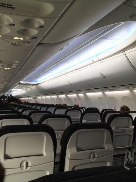 The Boeing Sky Interior provides updated and larger overhead bins, as well as LED lighting. Image from Alaska Airlines. 