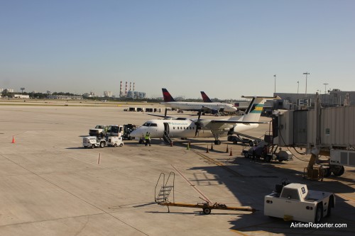 How many Dash 8's does it take to replace a Boeing 737? Two. The first one wasn't as colorful as the second (this is the 1st). Notice the air stairs going up to the jetway.