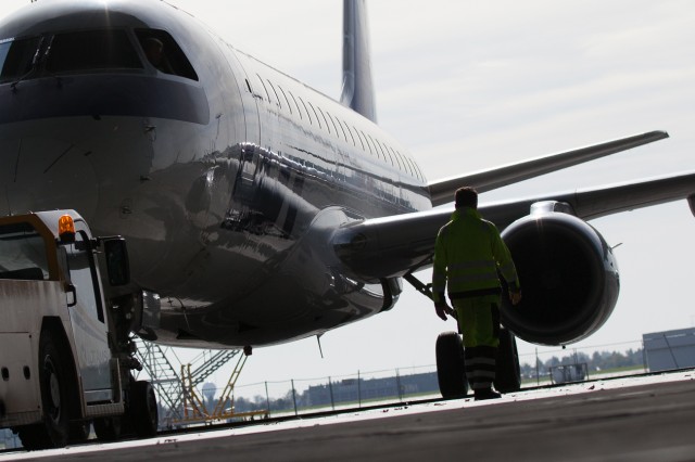 Done for the day, an airplane is pushed out of the hangar to the flight line.