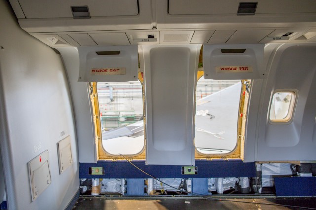 The open emergency exit doors over the wings.