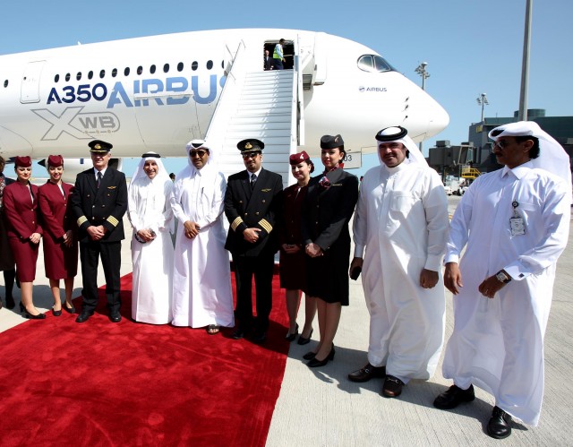 Qatar Airways Staff pose infront of the first A350XWB to land at Doha's new Hamad International Airport - Photo: Qatar Airways