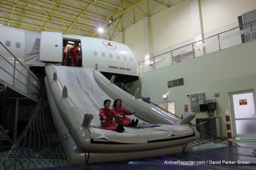 New flight attendants practicing their stuff. Notice the "A310-300" marking on the side of the fuselage.