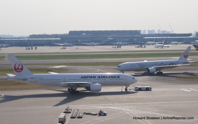 JAL 777s on the T1 ramp, with HND's International Terminal in the background