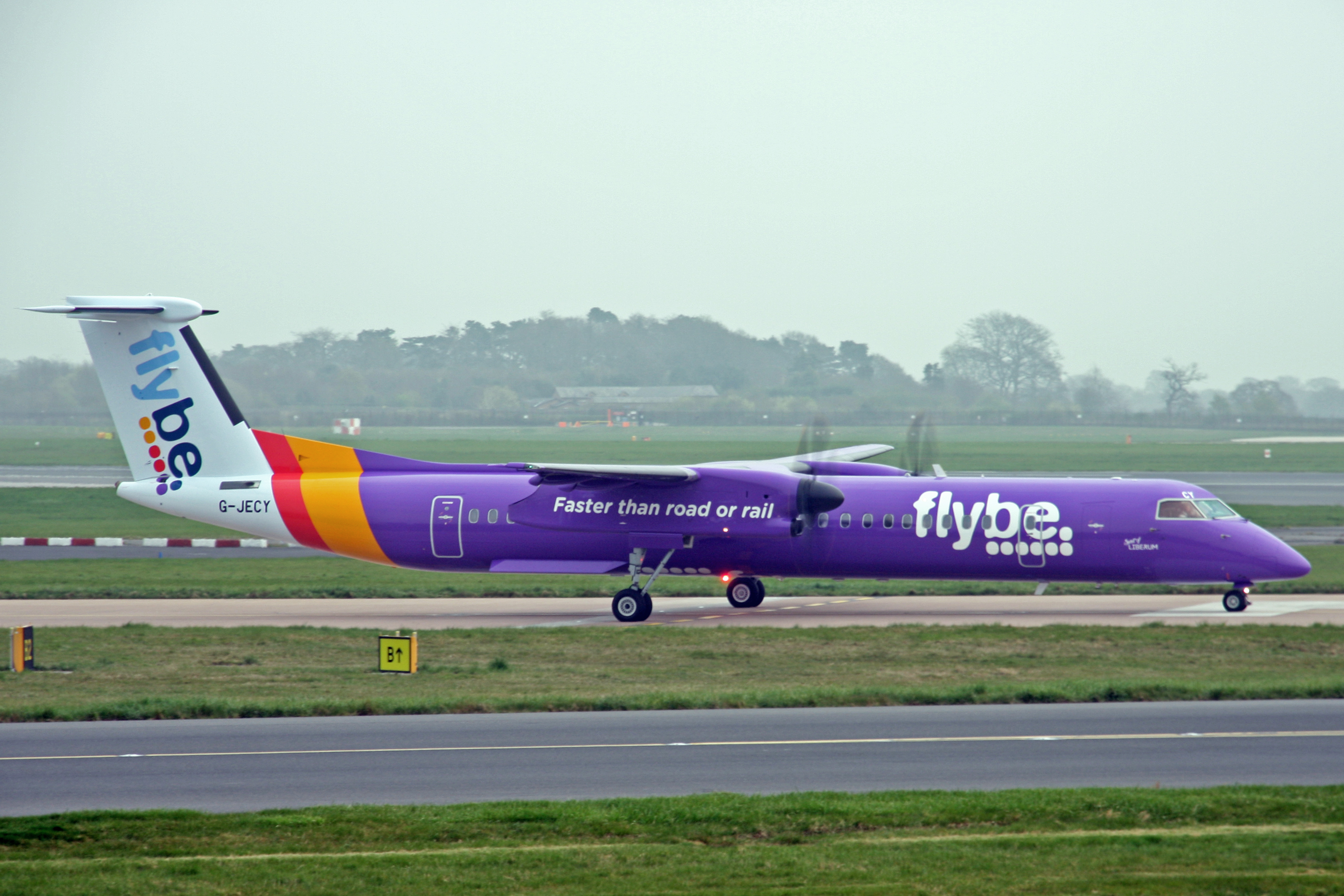 G-JECY Dash 8Q-402 in the new purple livery at Manchester, UK