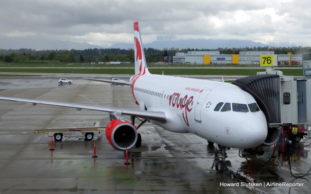 Air Canada rouge's inaugural YVR-LAS Airbus A319 flight at the gate on a rainy Vancouver morning.