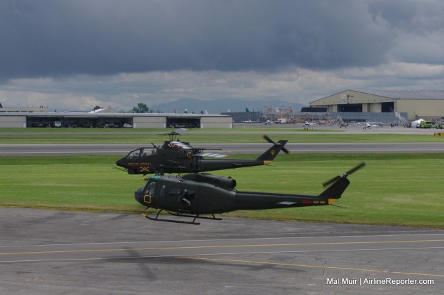 UH-1 Huey (foreground) and AH-1 Cobra (background) await their turn to Depart the Kilo 7 area for their flight demonstration