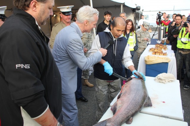 Local celebrity John Curley is emcee for the event while the fish gets filleted