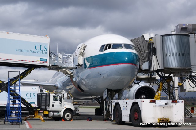 A Cathay Pacific Boeing 777-300 in the midst of a turnaround at YVR.