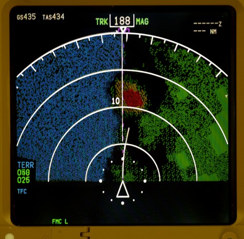 An EGPWS screen illustrates terrain above current flight level in red, directly ahead. Image courtesy of Honeywell Aero