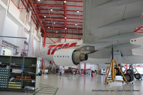 An Airbus A330 is lifted to have work done on it.
