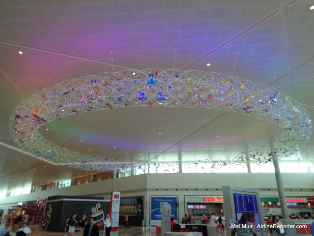 Very nice Artwork hanging from the ceiling at Dallas Love Field.  All through the frame work is different shaped and colored items.  I saw a few planes in there!