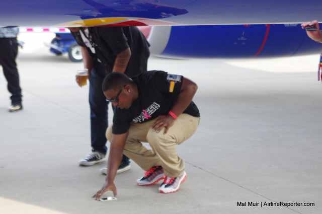 One of Southwest's employees sets himself up for a Heart Selfie underneath Heart Two
