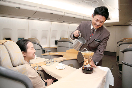 An Asiana Airlines senior purser makes hand dripped coffee during an onboard service. Photo:  Korea Times/Asiana Airlines