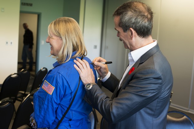 Dr Karen Reid, principal of Seren Lake Elemtary School in Mukilteo , WA, has her flight suit signed by astronaut Chris Hadfield. Photo: Kris Hull