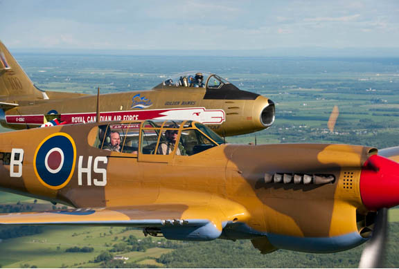 Chris Hadfield, in the Sabre, flies formation with his brother, David, in a P-40, with their father in the back seat. Photo: Peter Handley/VWoC