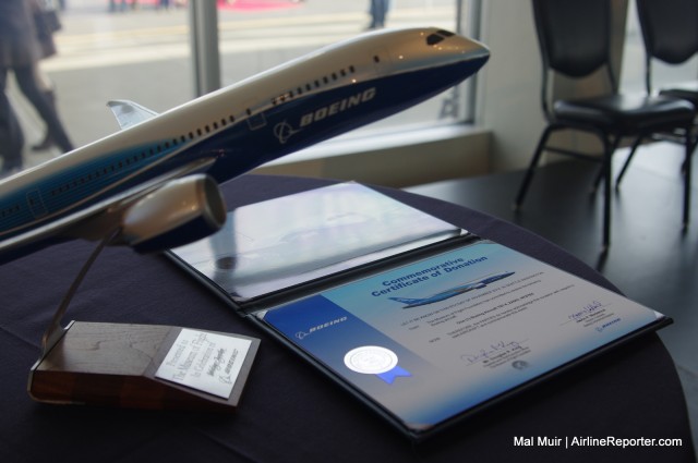 It wouldn't be a delivery ceremony without a Model and a Certificate right? Although this time the Museum gets it for free - Photo: Mal Muir | AirlineReporter.com