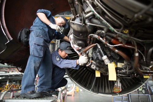 Mechanics work on the engine of a Boeing 747.