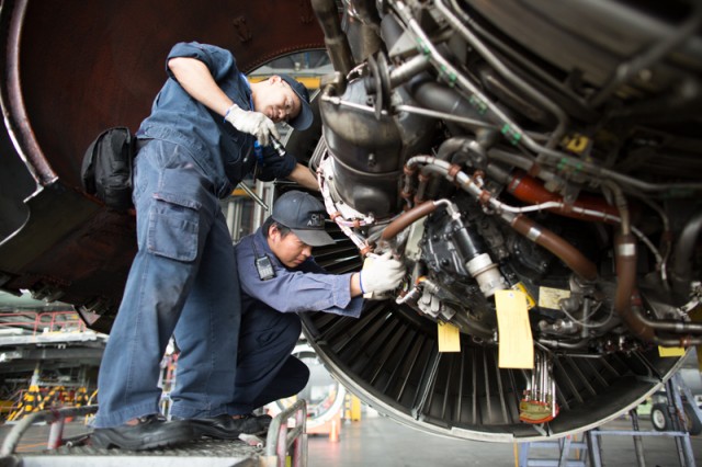 Mechanics work on the engine of a Boeing 747.