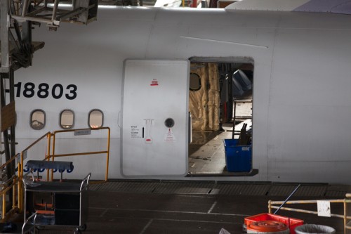 An emptied out interior is visible through the rear door of an Airbus A340-300.