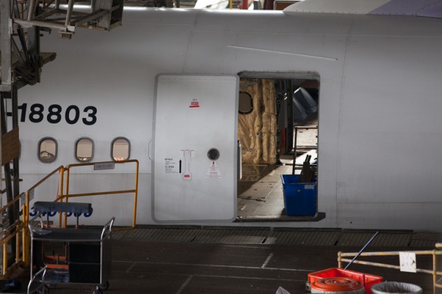 An emptied out interior is visible through the rear door of an Airbus A340-300.