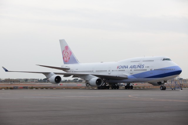 One of 13 China Airlines Boeing 747s rests on a ramp outside the hangar.