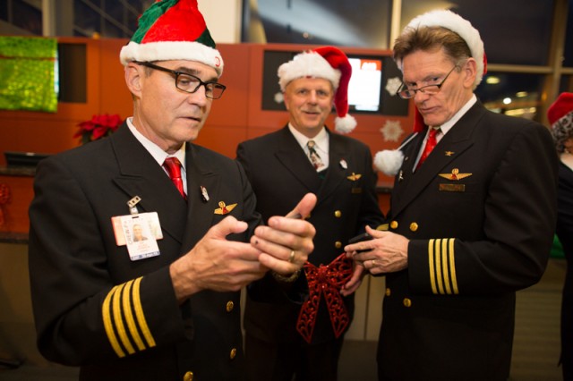 The pilots for Delta flight 1225, service from Seattle to the North Pole, check emails before the flight.