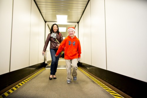 Ready for the flight, a child runs down the jetway to the waiting Airbus A330 jet.