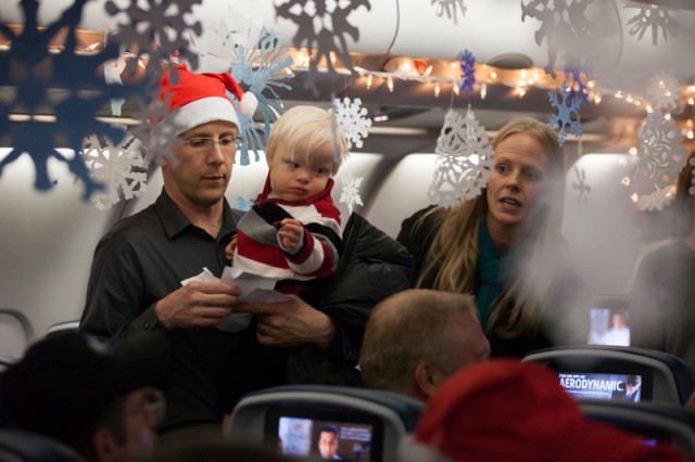 Passengers for the flight look for their seat assignments to settle in for the 90-minute flight.