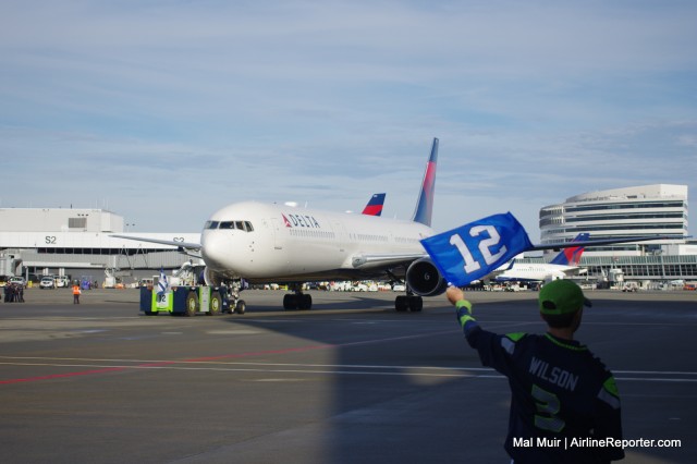 This Seahawks fan may be waving goodbye to a Delta flight, but he can get priority boarding on Alaska Airlines just by wearing his Russell Wilson jersey - Photo: Mal Muir | AirlineReporter.com