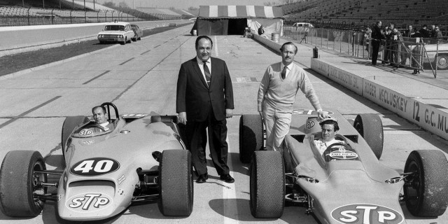 Andy Granatelli and two STP racecars - Photo: Indianapolis Speedway