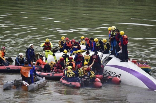 Rescuers are on top of the crashed ATR-72 - Photo: Eddie Yu