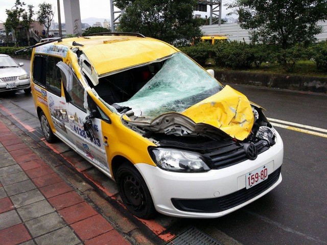 The taxi cab hit by the ATR-72 seen after being moved - Photo: Eddie Yu